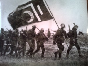 Ottoman soldiers carry a black military flag or banner during the First World War